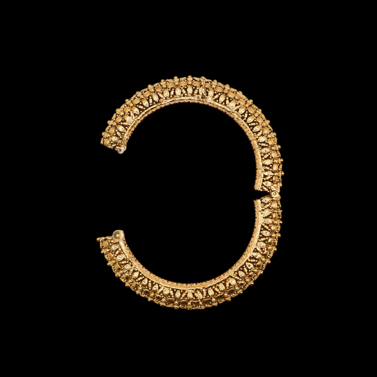 Side view of ornate intricate Indian bangle hinge opening