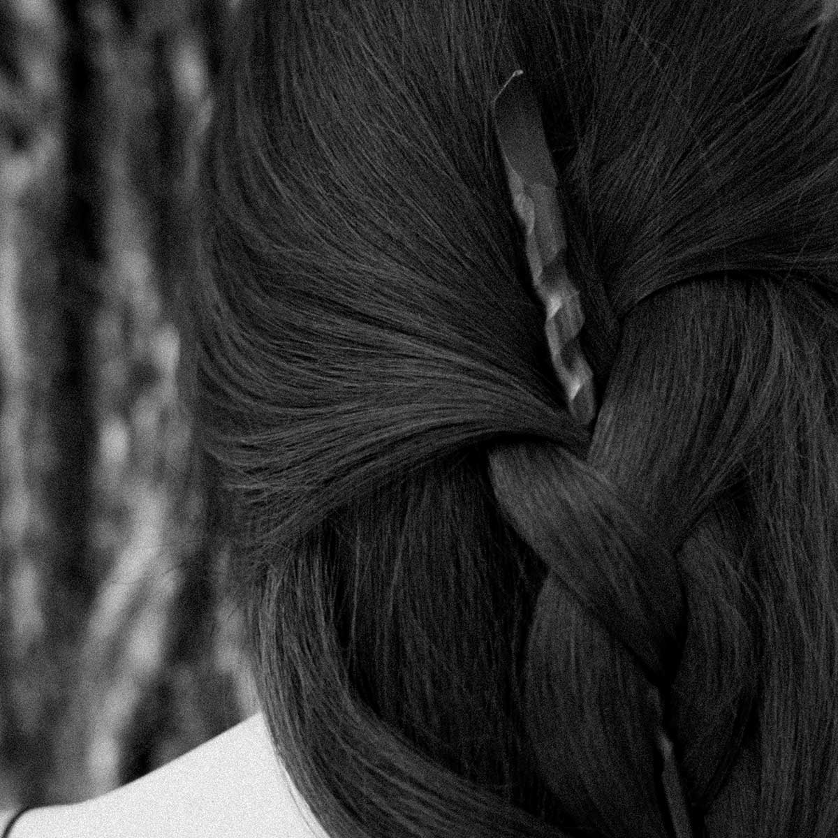 Twisted wooden hair stick wand in a woman's hair