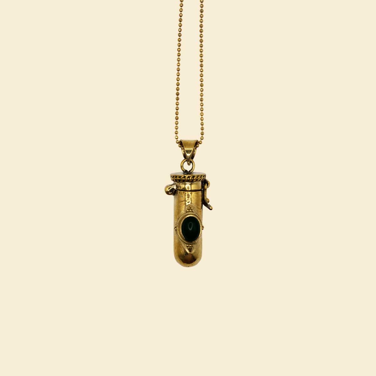 Golden brass pendant with a black gemstone