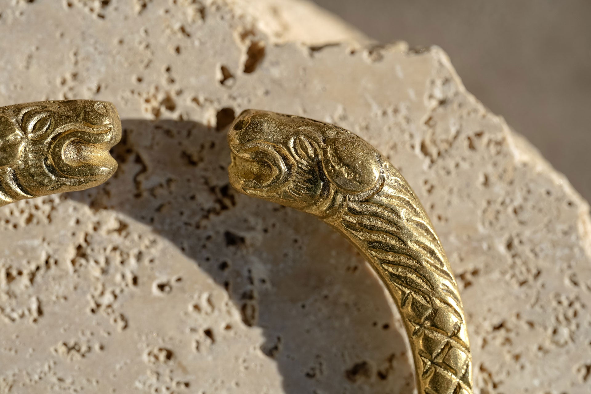 Pure brass bangle cuff style with lion shape head kept on stone