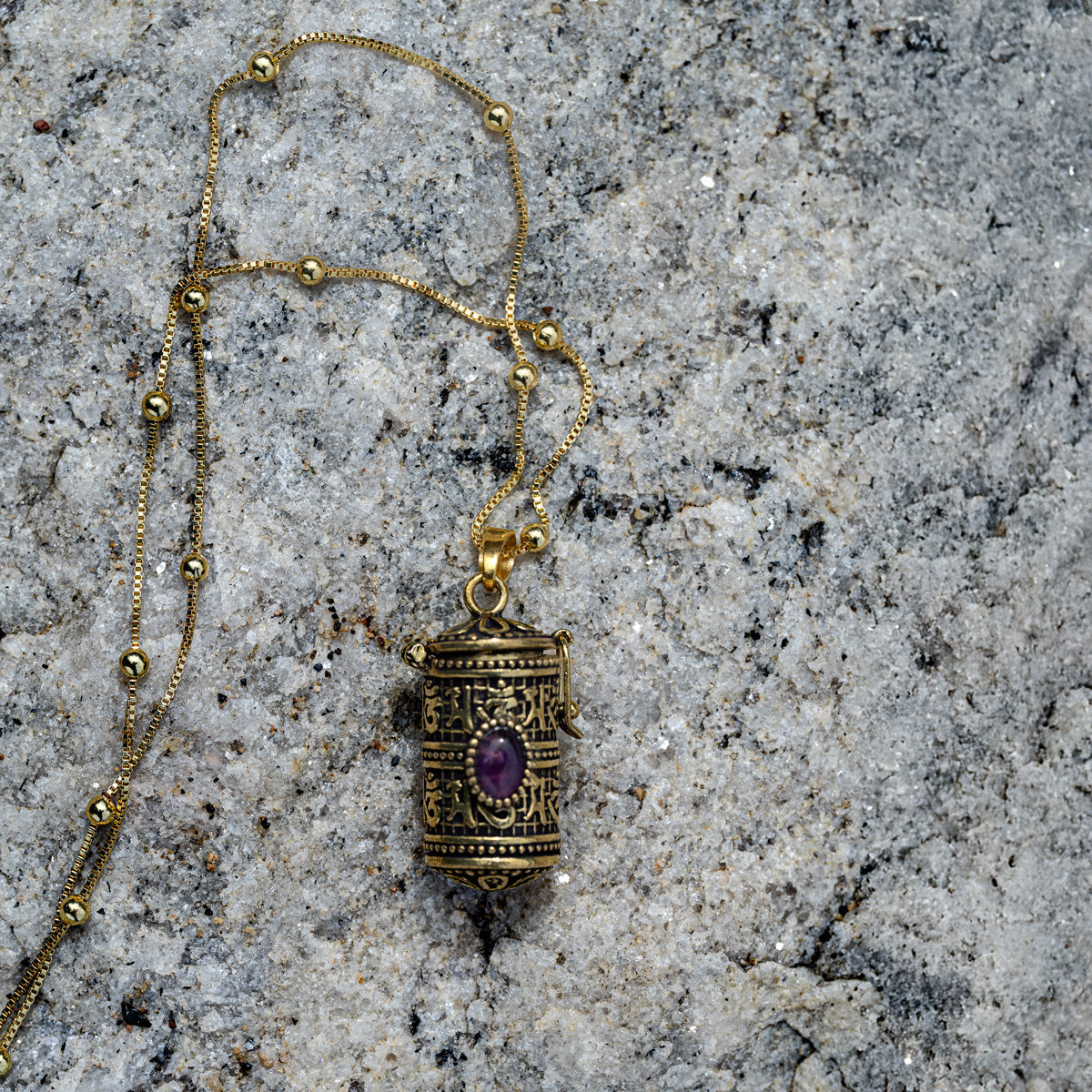Engraved Tibetan mediation pendant with storage and amethyst gemstone