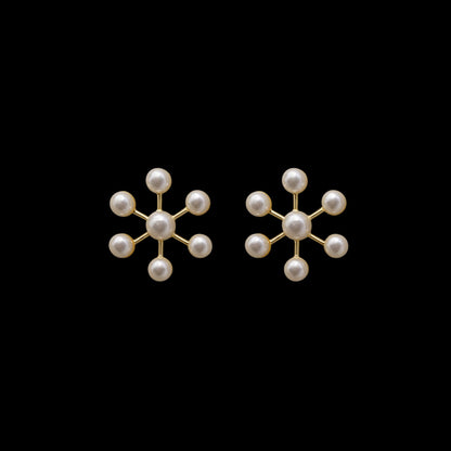 A pair of earrings with decorative geometric arrangement of pearls