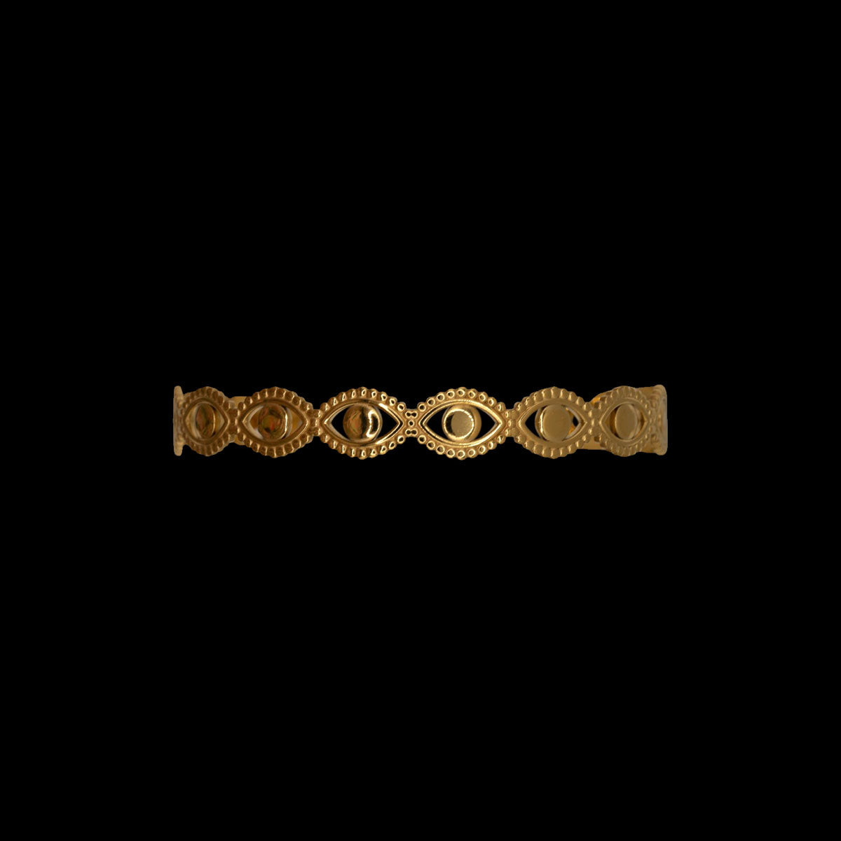 Gold bracelet with intricate design on a black background