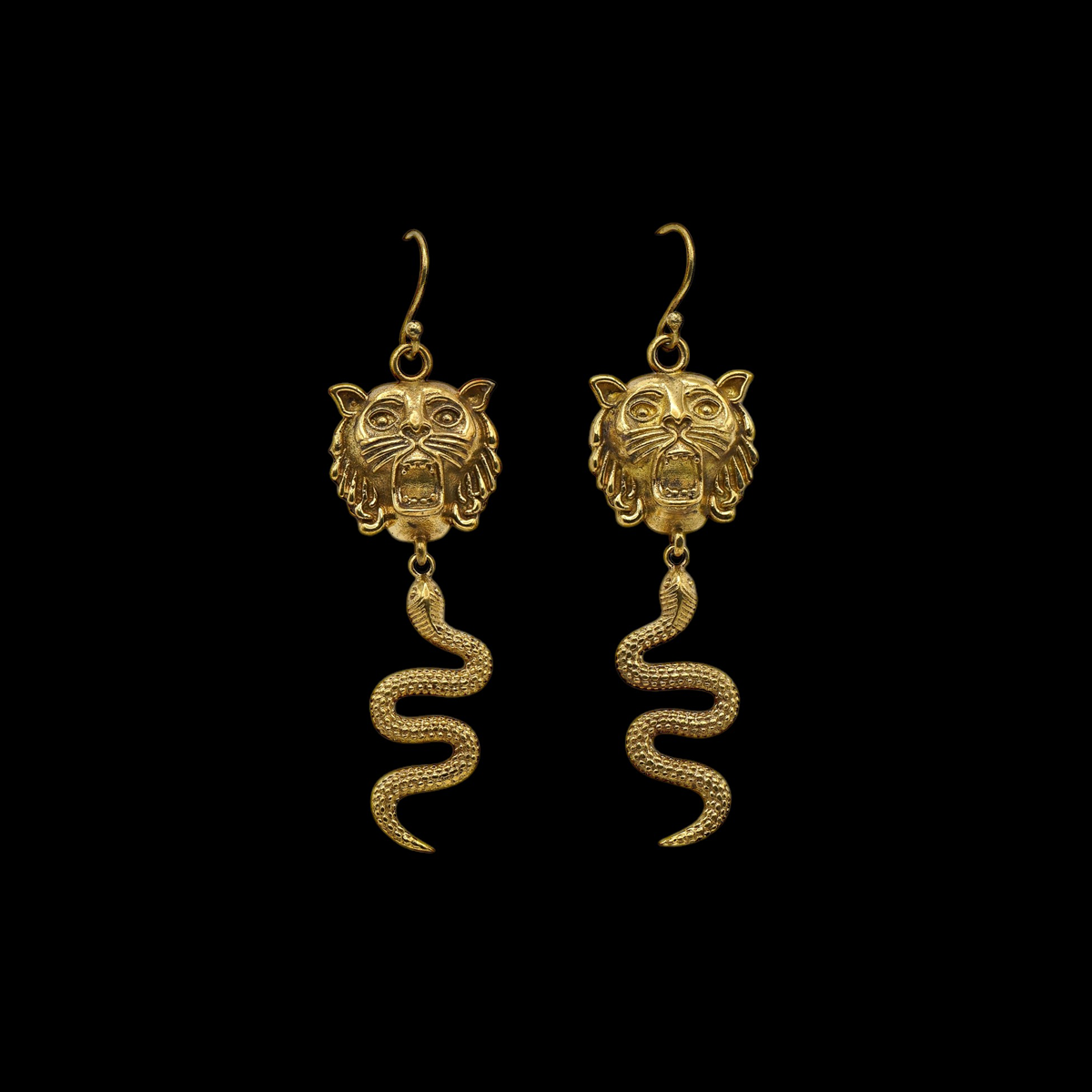 A pair of golden antique lion and snake earrings