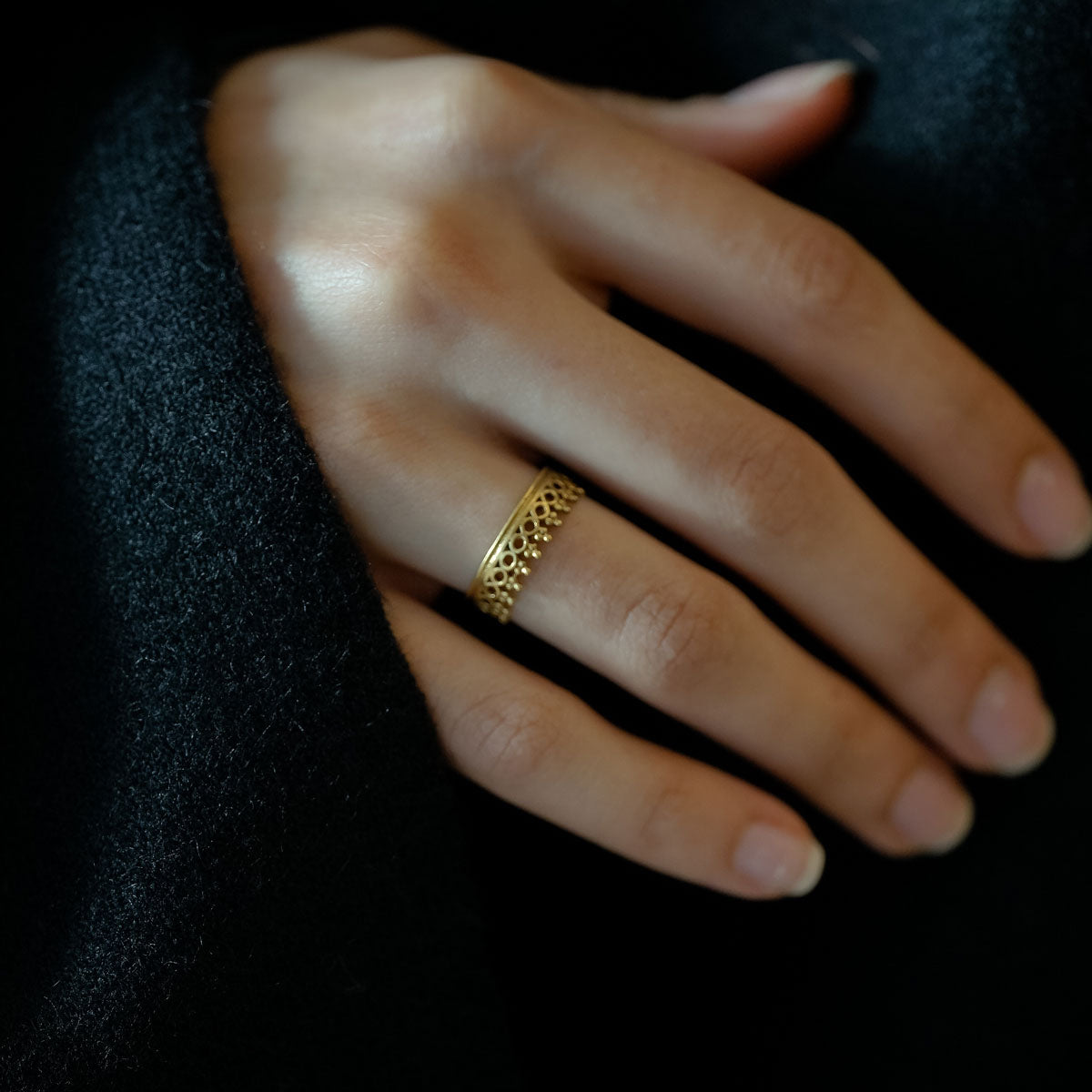Woman wearing an antique brass golden ring 