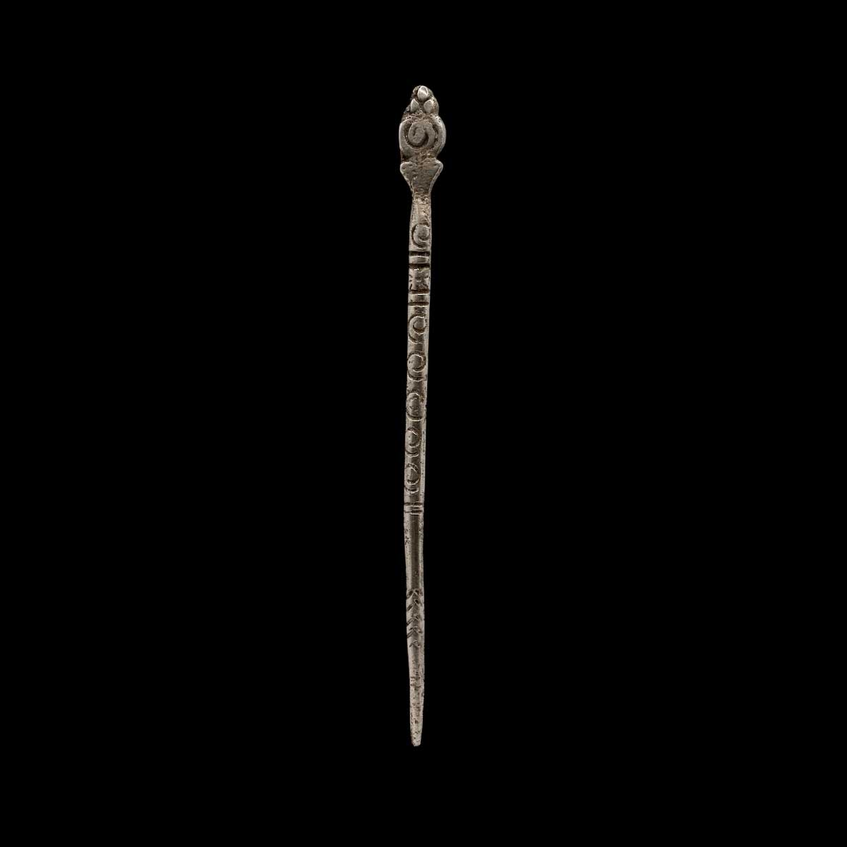 Decorative metal hairpin on a black background