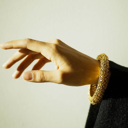 Woman wearing an ornate intricate Indian bangle hinge opening
