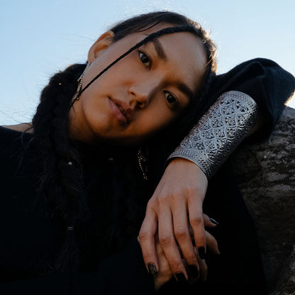 Women wearing a black outfit with intricate silver indian intricate arm band cuff