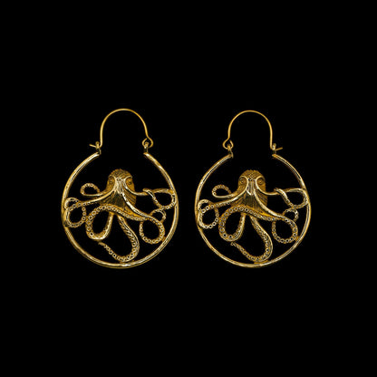 Golden octopus earrings on a black background