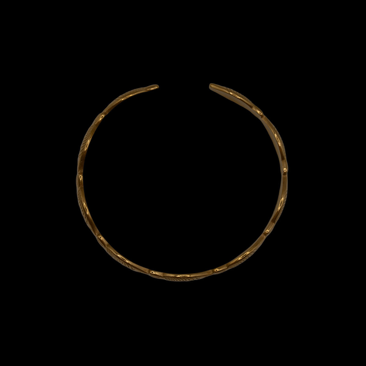 Side view of gold plated fish shaped bracelet