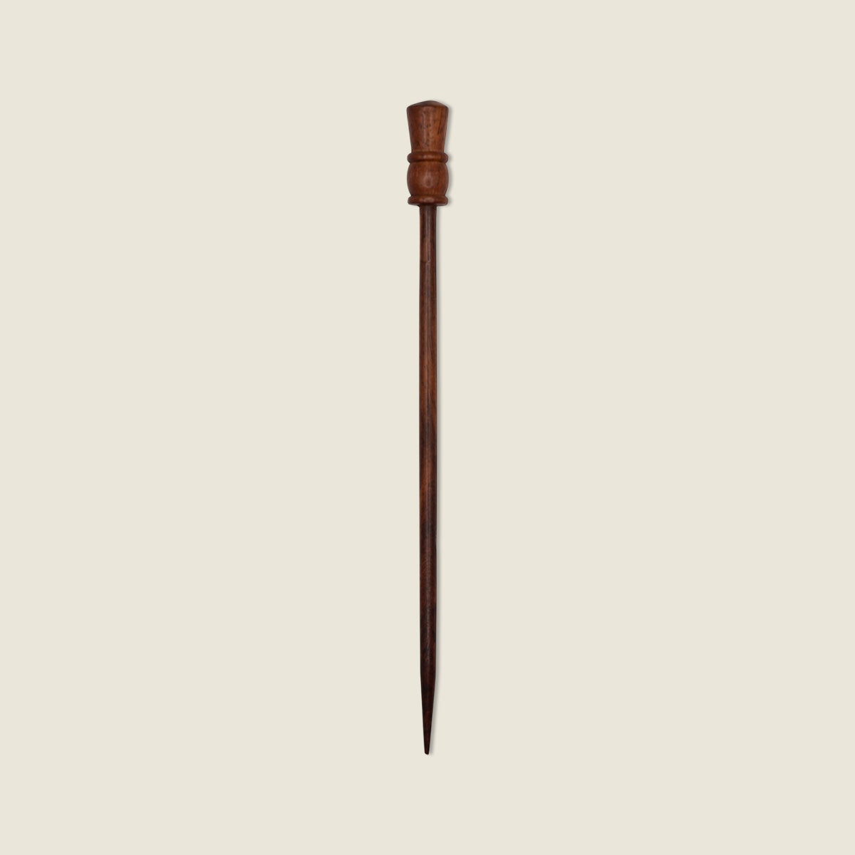 Wooden hairpin on a beige background