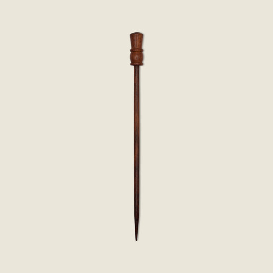 Wooden hairpin on a beige background