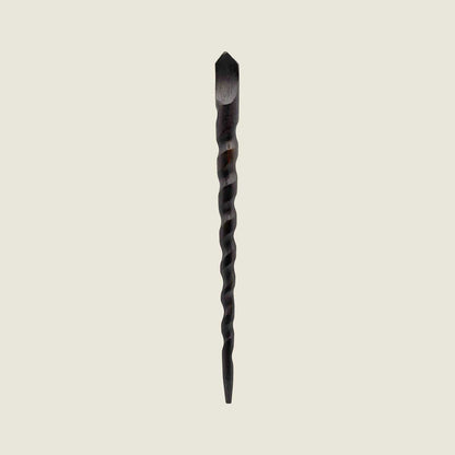 Twisted wooden hair stick wand on a beige background