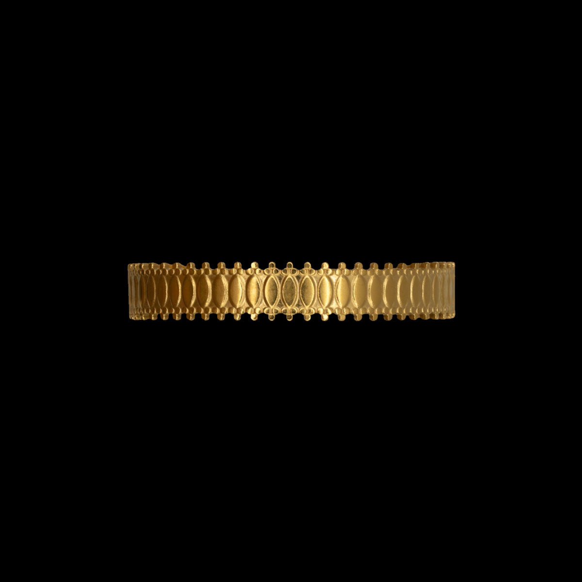 Matte gold plated bracelet with intricate border on a black background