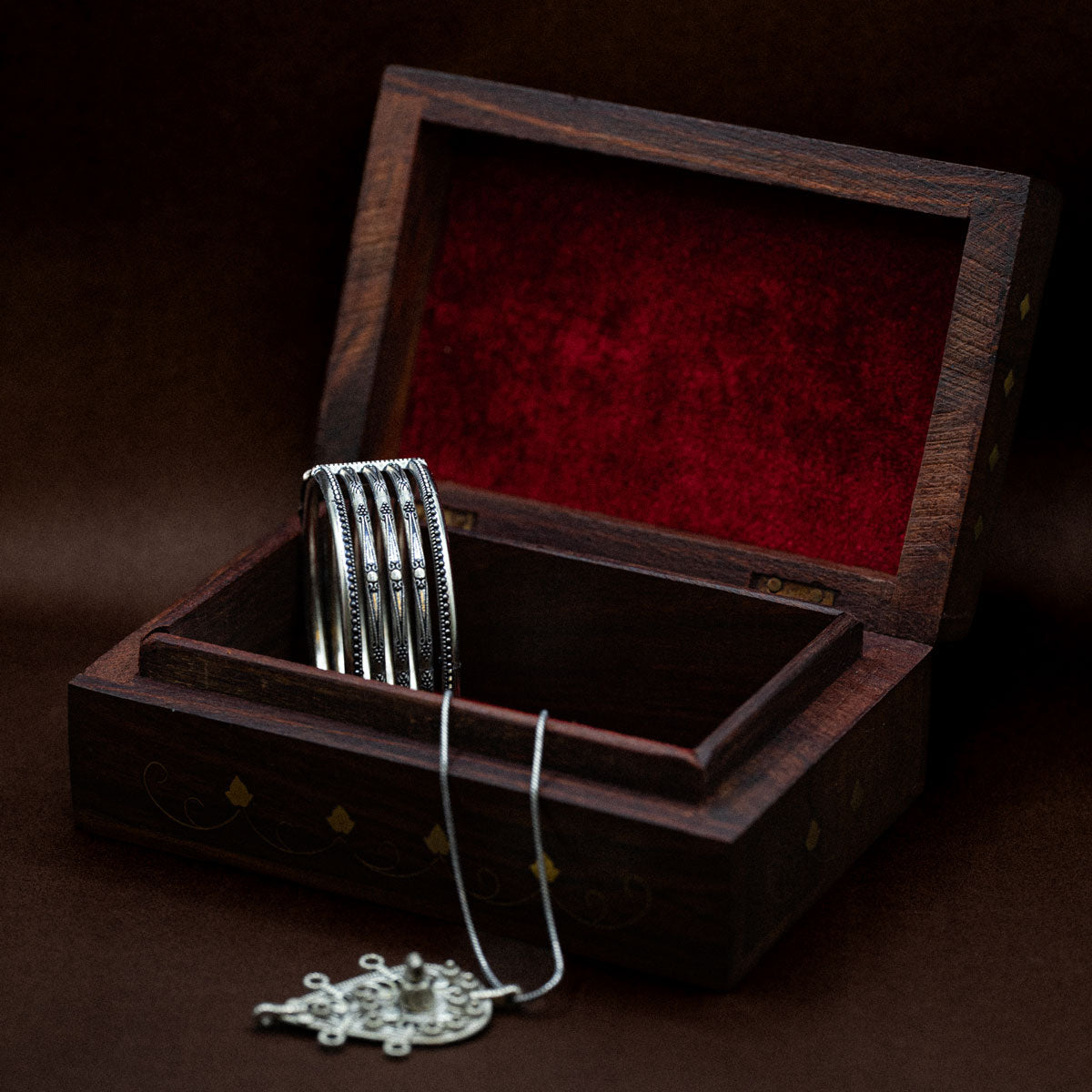 Decorative wooden gift, hand-carved, box with golden brass etchings with silver jewellery inside