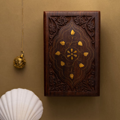 Decorative wooden gift, hand-carved, box with golden brass etchings on a brown background
