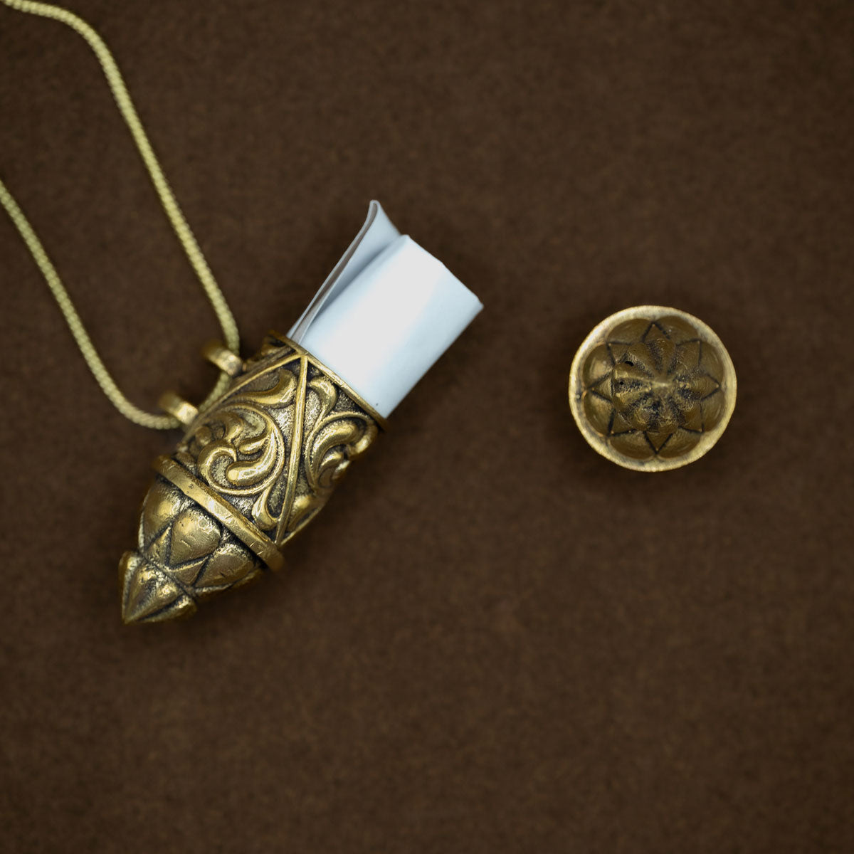 Antique golden brass necklace with an ornate pendant with a wishkeeping scroll inside