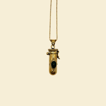Golden brass pendant with a black gemstone